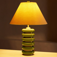 Greyson Table Lamp by Soho Home. High-gloss olive lacquered base. Antique brass details. Linen shade. Inspired by Soho House.