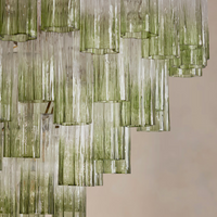 Chiara Chandelier by Soho Home. Multiple green ombre, scalloped glass tubular sections. Hand-finished by skilled artisans. Inspired by Soho Home.
