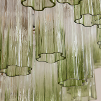 Chiara Chandelier by Soho Home. Multiple green ombre, scalloped glass tubular sections. Hand-finished by skilled artisans. Inspired by Soho Home.