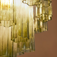 Chiara Chandelier by Soho Home. Multiple green ombre, scalloped glass tubular sections. Hand-finished by skilled artisans. Inspired by Soho Home.