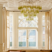Chiara Chandelier by Soho Home. Multiple green ombre, scalloped glass tubular sections. Hand-finished by skilled artisans. Inspired by Soho Home.