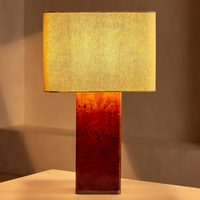 The Remi table lamp by Soho Home. Designed with a rectangular base in dark oak mappa burl timber. Complemented with a natural linen shade. Inspired by Soho House.