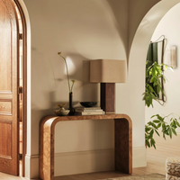 The Remi table lamp by Soho Home. Designed with a rectangular base in dark oak mappa burl timber. Complemented with a natural linen shade. Inspired by Soho House.