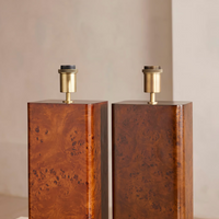 The Remi table lamp by Soho Home. Designed with a rectangular base in dark oak mappa burl timber. Complemented with a natural linen shade. Inspired by Soho House.