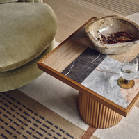 Cavern Side Table by Soho Home. A mix of travertine and honed Jade Shell, Golden Portoro and Grey Pesco marble with inlay pattern. Solid oak fluted base. Inspired by Soho House.