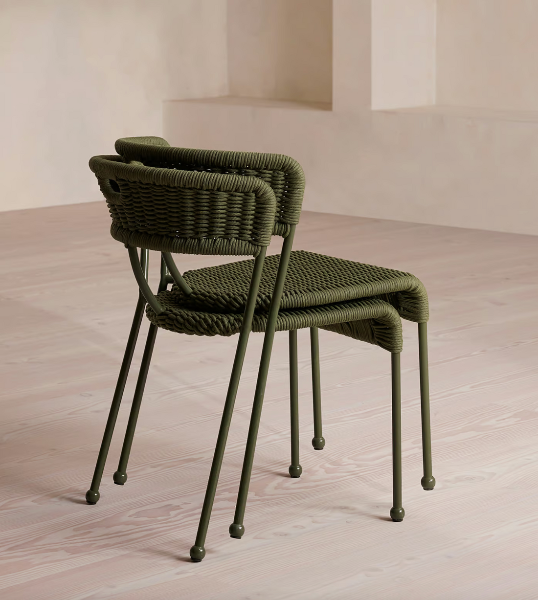 Lisson dining chairs by Soho Home  crafted using a bespoke hand-dyed woven rope suspension. Olive green colour and stackable design.
