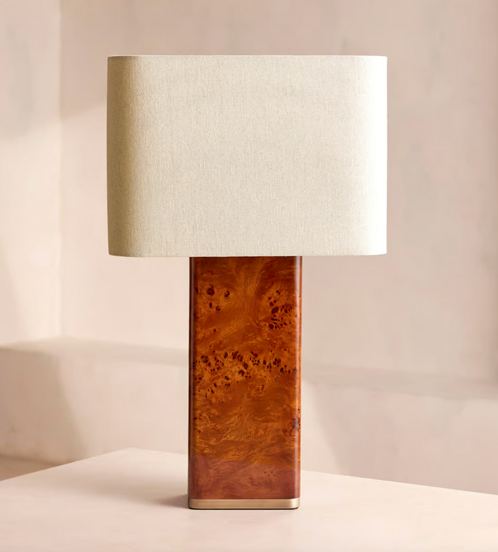 The Remi table lamp by Soho Home.  Designed with a rectangular base in dark oak mappa burl timber. Complemented with a natural linen shade. Inspired by Soho House.