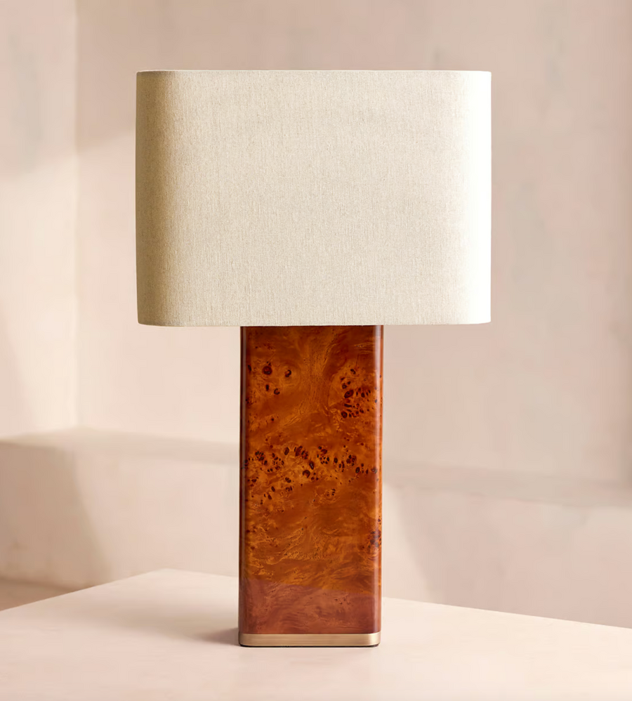 The Remi table lamp by Soho Home.  Designed with a rectangular base in dark oak mappa burl timber. Complemented with a natural linen shade. Inspired by Soho House.