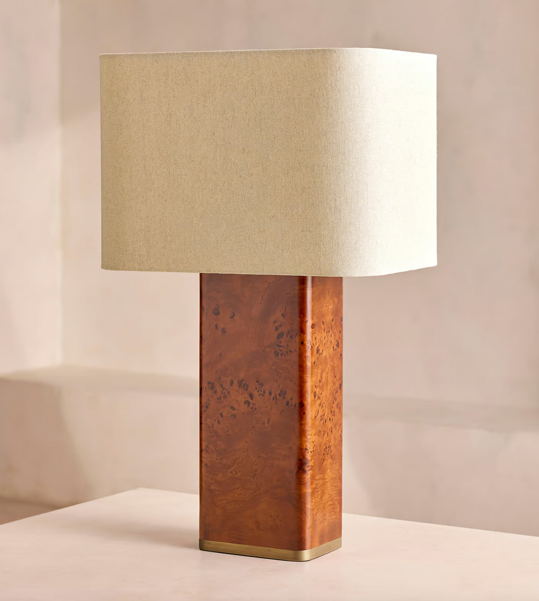 The Remi table lamp by Soho Home.  Designed with a rectangular base in dark oak mappa burl timber. Complemented with a natural linen shade. Inspired by Soho House.