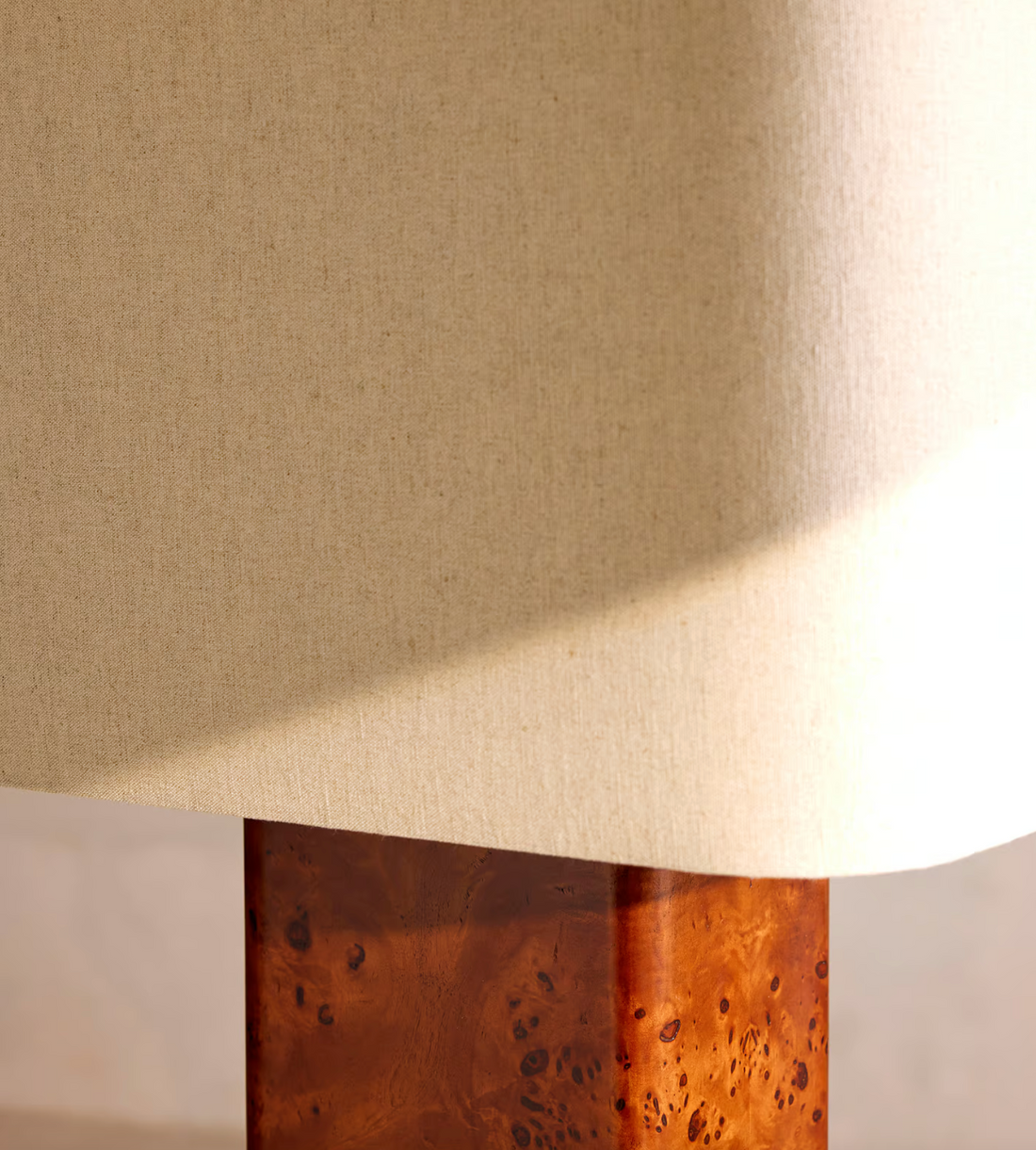 The Remi table lamp by Soho Home.  Designed with a rectangular base in dark oak mappa burl timber. Complemented with a natural linen shade. Inspired by Soho House.