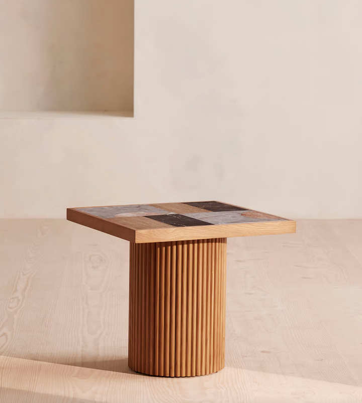 Cavern Side Table by Soho Home. A mix of travertine and honed Jade Shell, Golden Portoro and Grey Pesco marble with inlay pattern. Solid oak fluted base. Inspired by Soho House.