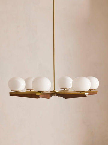 Demarco chandelier by Soho Home. Antique brass details, chandelier features six oval glass orbs, solid oak. Mid century inspired. Inspired by Soho House.